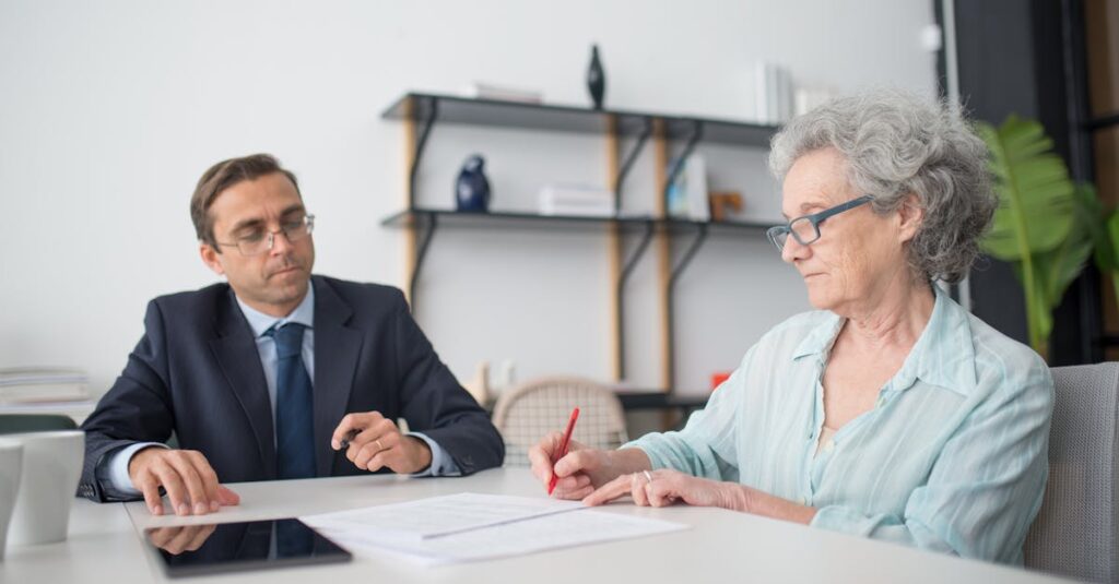 Elderly woman signing paperwork in modern office with consultant.